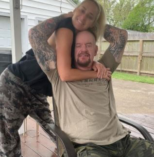 The Undertaker and his wife Michelle McCool, posing for a picture